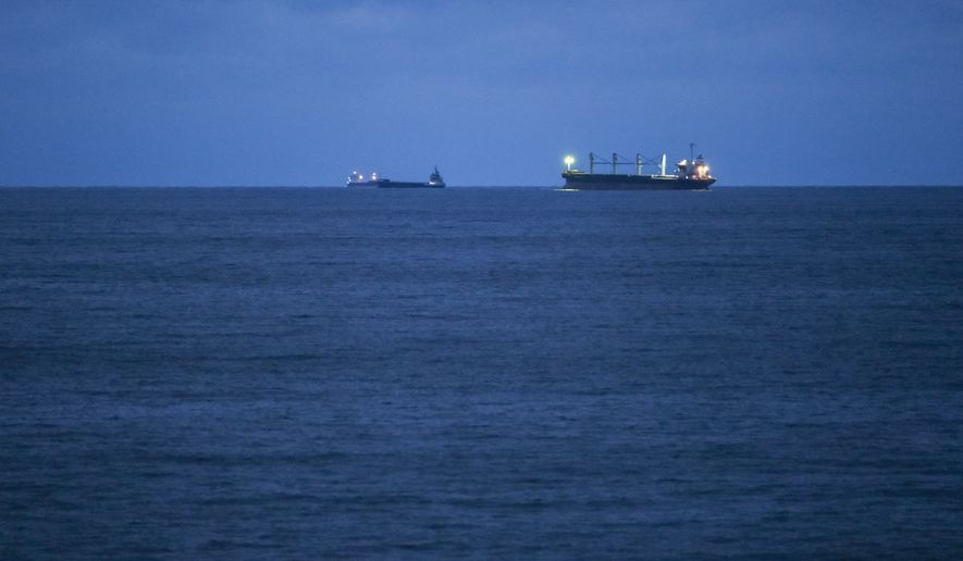 Bulgarian Navy emergency rescue tug Mizar is seen near the ship Azov Concord, where four sailors rescued from the drone-attacked and sunk ship HS Dignity await transportation to the port of Varna, Bulgaria, late Tuesday, Oct. 13, 2026. (Moreto.net via AP)