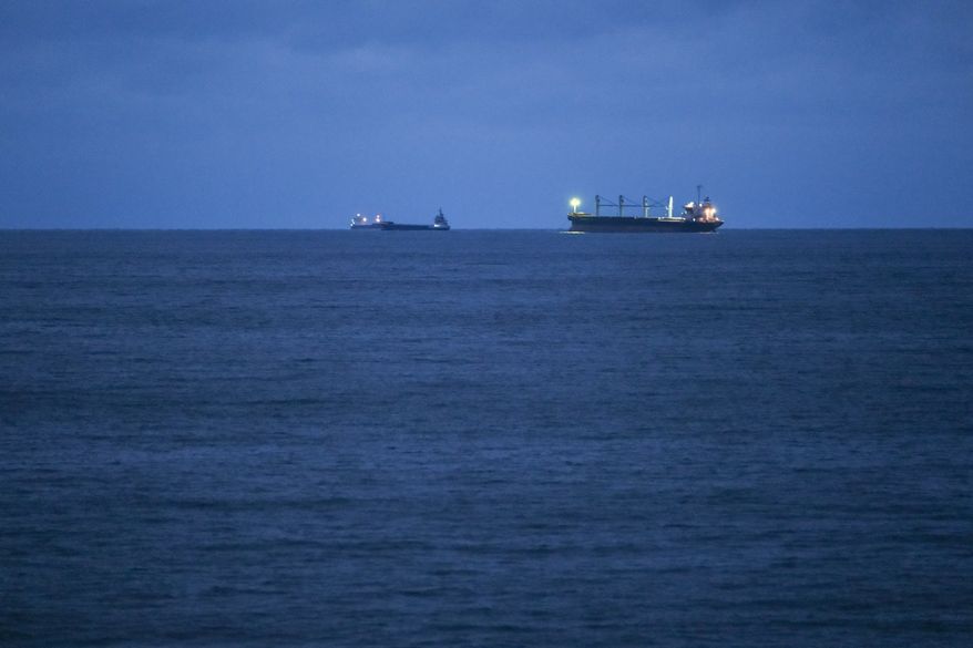 Bulgarian Navy emergency rescue tug Mizar is seen near the ship Azov Concord, where four sailors rescued from the drone-attacked and sunk ship HS Dignity await transportation to the port of Varna, Bulgaria, late Tuesday, Oct. 13, 2026. (Moreto.net via AP)