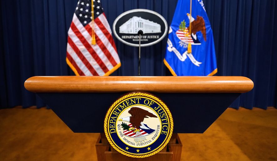 The U.S. Department of Justice logo is seen on a podium before a press conference at the Justice Department in Washington on May 6, 2025. (AP Photo/Julia Demaree Nikhinson) **FILE**