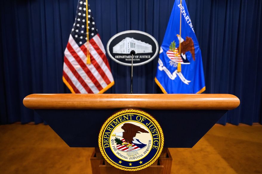 The U.S. Department of Justice logo is seen on a podium before a press conference at the Justice Department in Washington on May 6, 2025. (AP Photo/Julia Demaree Nikhinson) **FILE**