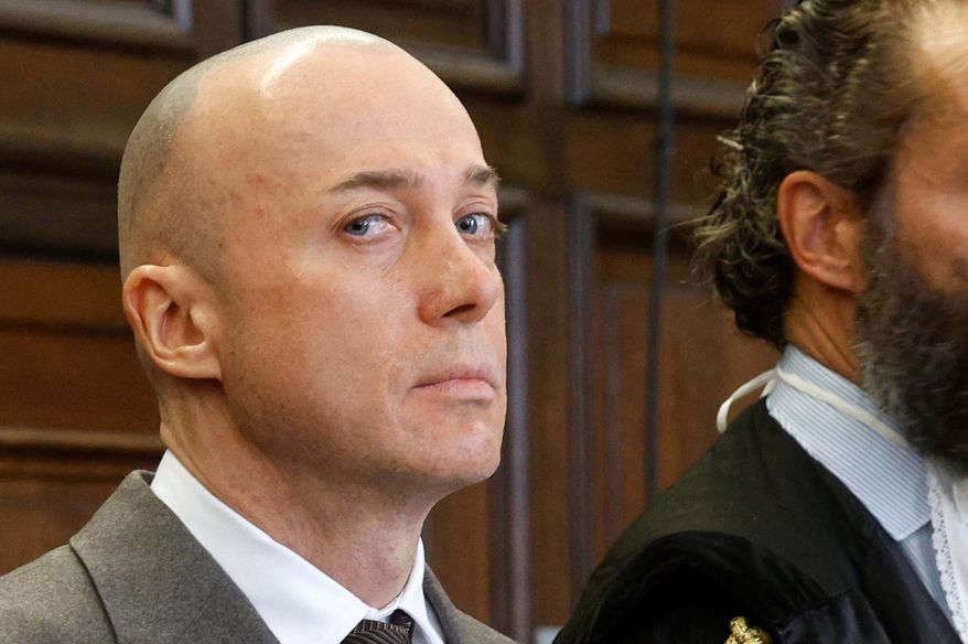 The defendant, Serhii Kuznietsov, left, stands near his attorneys during a trial at the Hanseatic Higher Regional Court, in Hamburg, Germany, Wednesday, Oct. 14, 2026. (Markus Scholz/dpa via AP)