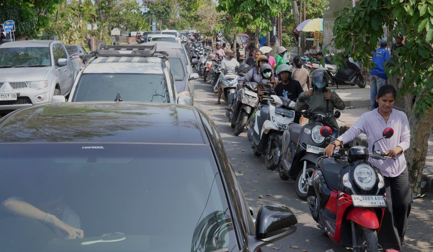 People queue at a gas station amid a fuel shortage in Denpasar, Bali, Indonesia, Wednesday, Oct. 14, 2026. (AP Photo/Firdia Lisnawati)
