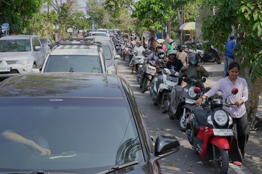 People queue at a gas station amid a fuel shortage in Denpasar, Bali, Indonesia, Wednesday, Oct. 14, 2026. (AP Photo/Firdia Lisnawati)