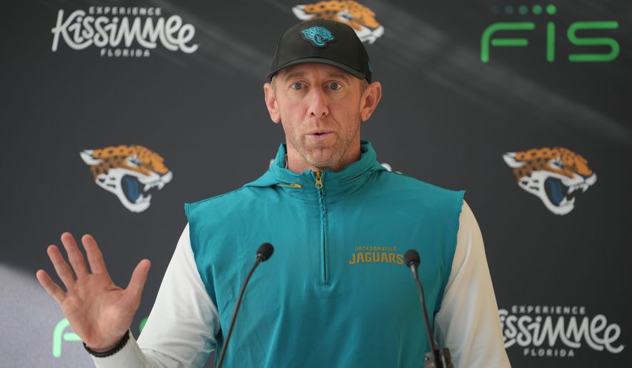Jacksonville Jaguars head coach Liam Coen speaks to the media before an NFL football practice in Hertfordshire, England, Wednesday, Oct. 14, 2026. (AP Photo/Kin Cheung)