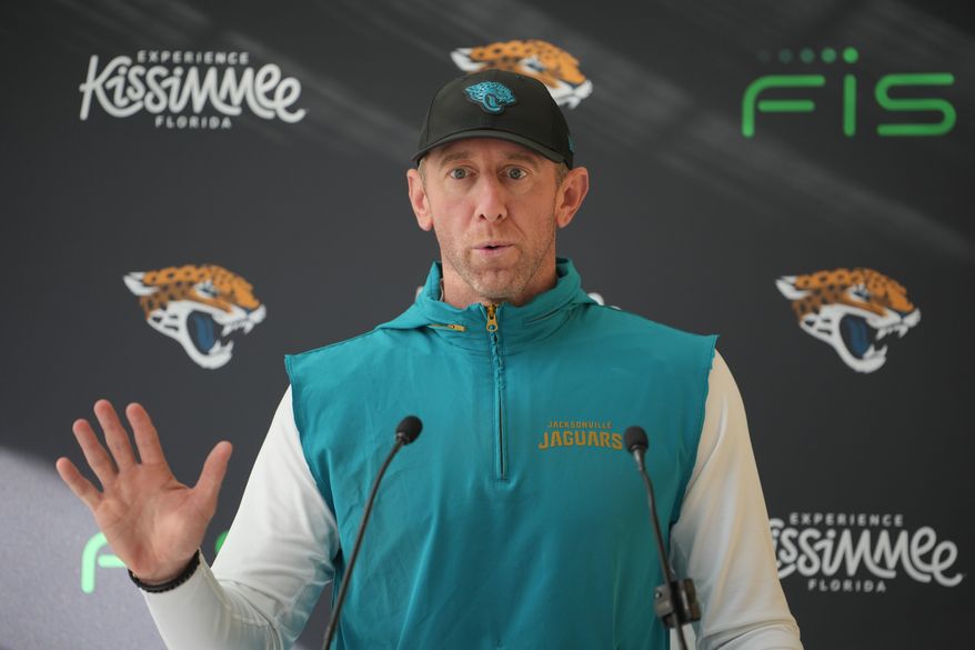 Jacksonville Jaguars head coach Liam Coen speaks to the media before an NFL football practice in Hertfordshire, England, Wednesday, Oct. 14, 2026. (AP Photo/Kin Cheung)