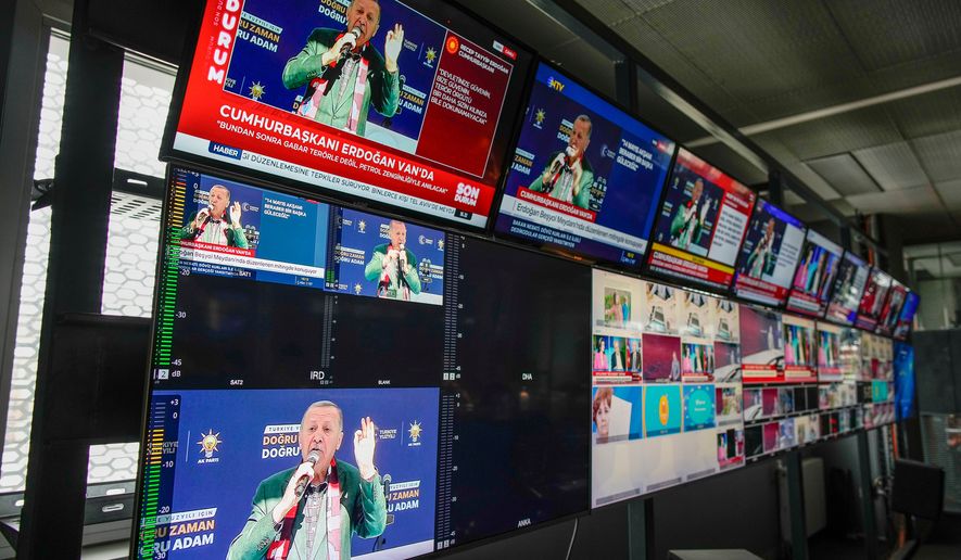 FILE -Screens, placed in Turkish Halk TV news channel headquarters, display Turkish President and People's Alliance's presidential candidate Recep Tayyip Erdogan speaking during a rally, in Istanbul, Turkey, May 5, 2023. (AP Photo/Emrah Gurel, File)