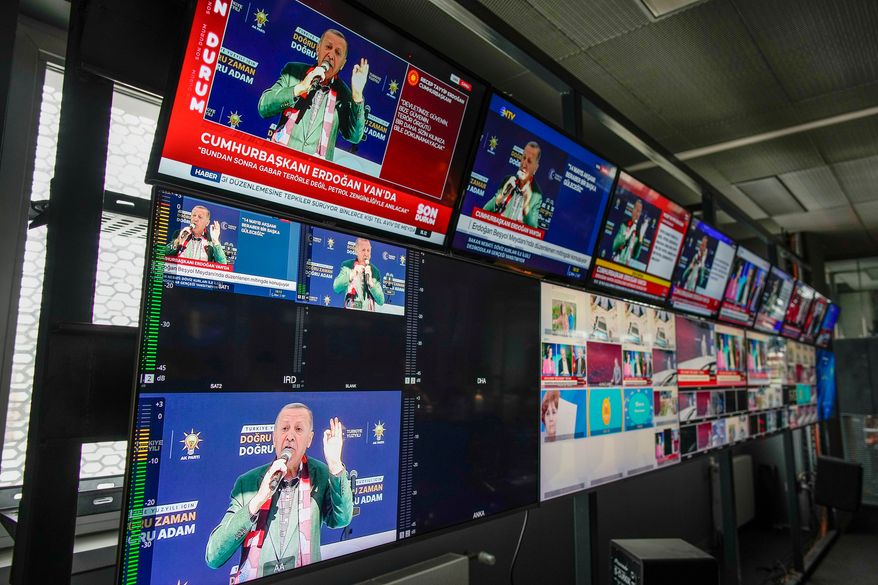 FILE -Screens, placed in Turkish Halk TV news channel headquarters, display Turkish President and People's Alliance's presidential candidate Recep Tayyip Erdogan speaking during a rally, in Istanbul, Turkey, May 5, 2023. (AP Photo/Emrah Gurel, File)