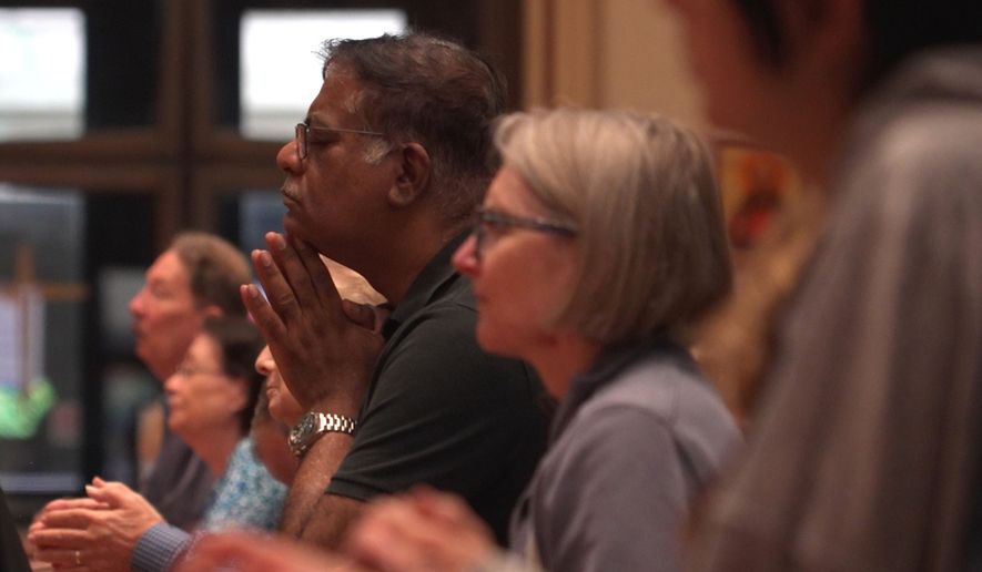 In this screengrab made from video, people pray at a votive mass for Pope Leo XIV in light of his lung cancer diagnosis at Holy Name Cathedral in Chicago, Wednesday, Oct. 14, 2026. (AP Photo/Laura Bargfeld)