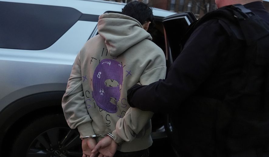 FILE - Deportation officers with Enforcement and Removal Operations in U.S. Immigration and Customs Enforcement's New York City field office arrest Wilmer Patricio Medina-Medina during an early morning operation, in the Bronx borough of New York, Dec. 17, 2024. (AP Photo/Julia Demaree Nikhinson, File)