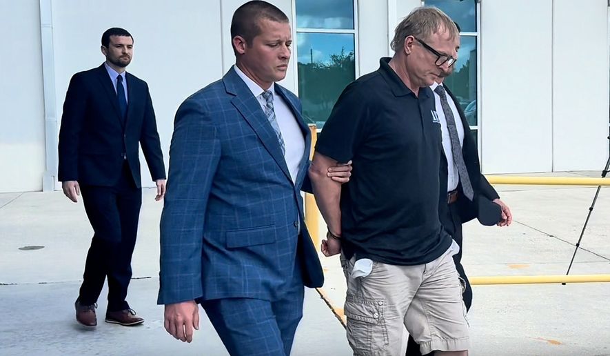 In this image taken from video released by the Orlando Police Department, Dale Smith Jr. is taken into custody in Orlando, Fla., on Wednesday, Oct. 14, 2026. (Orlando Police Department via AP)