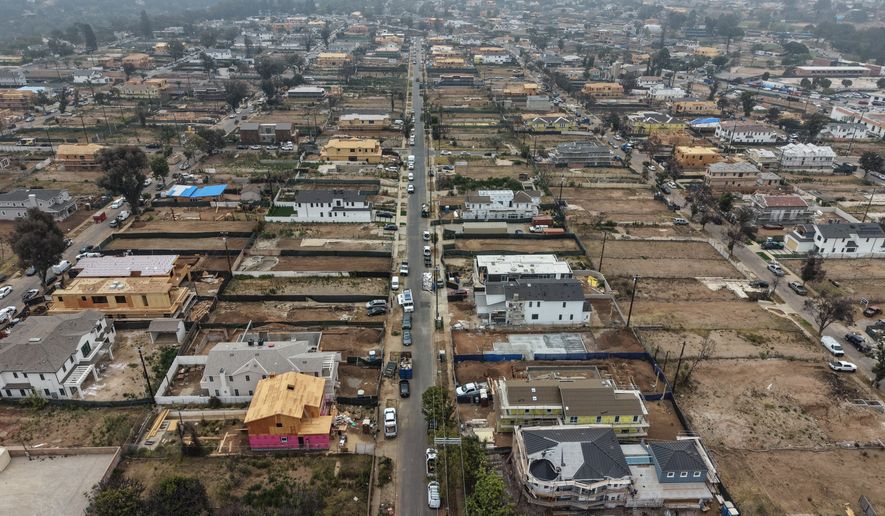 FILE - An aerial view shows homes under construction amid empty lots, June 4, 2026, more than a year after the Palisades Fire in the Pacific Palisades neighborhood of Los Angeles. (AP Photo/Jae C. Hong, File)