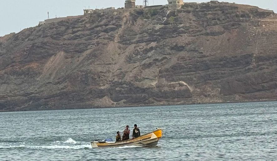 FILE - A boat motors under Al-Maashiq Presidential Palace, at top, in Aden, Yemen, Aug. 20, 2024. (AP Photo, File)