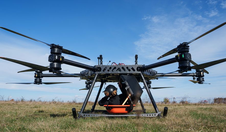 A representative of the SkyFall drone company climbs into a medical module of the SkyGate drone before a demonstration flight at an undisclosed location in Ukraine, Wednesday, Oct. 14, 2026. (AP Photo/Evgeniy Maloletka)