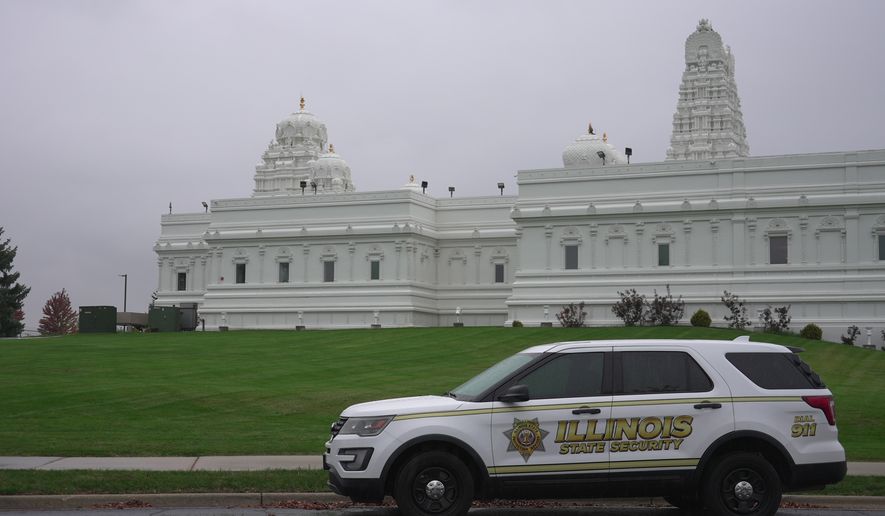 A security vehicle is parked outside of Sri Venkateswara Swami (Balaji) Temple in Aurora, Ill., Thursday, Oct. 15, 2026. (AP Photo/Laura Bargfeld)