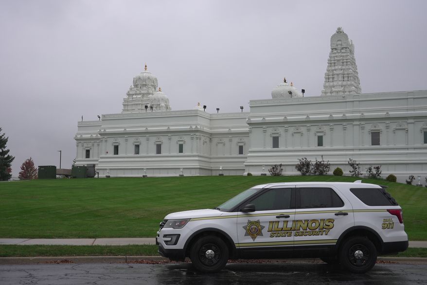A security vehicle is parked outside of Sri Venkateswara Swami (Balaji) Temple in Aurora, Ill., Thursday, Oct. 15, 2026. (AP Photo/Laura Bargfeld)