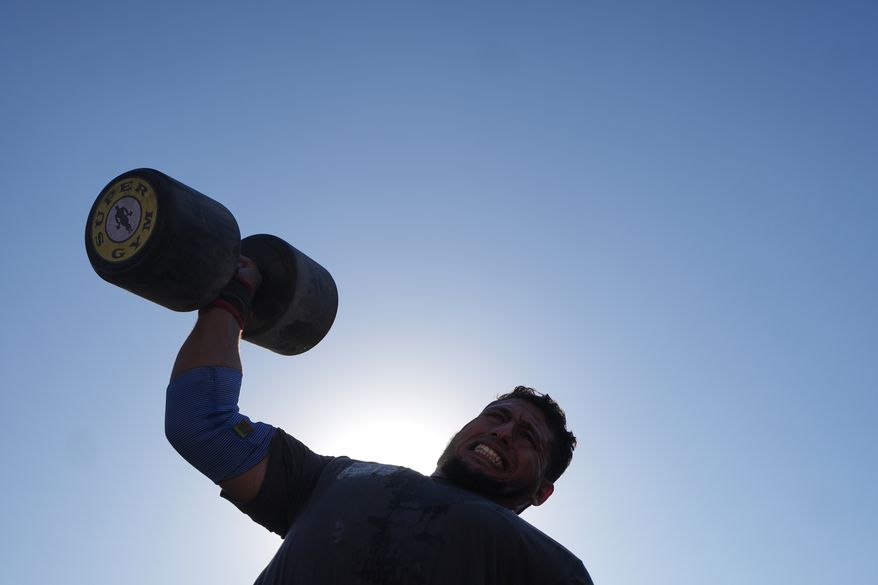 A Palestinian competitor lifts a dumbbell during the Palestine Strongman Championship in Gaza City, Friday, Oct. 16, 2026. (AP Photo/Jehad Alshrafi)
