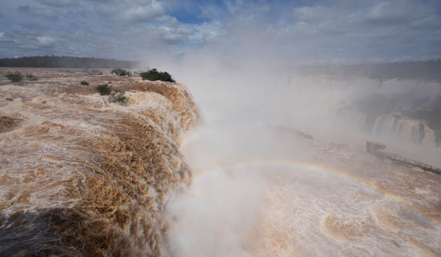 Water cascades over the cliffs of Iguazu Falls in Foz do Iguacu, Brazil, Friday, Oct. 16, 2026. (AP Photo/Jorge Saenz)
