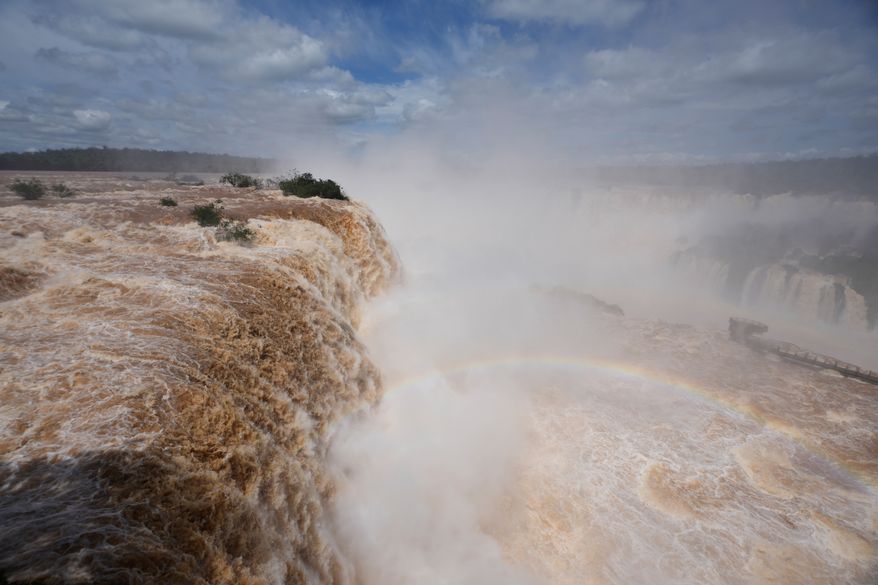 Water cascades over the cliffs of Iguazu Falls in Foz do Iguacu, Brazil, Friday, Oct. 16, 2026. (AP Photo/Jorge Saenz)