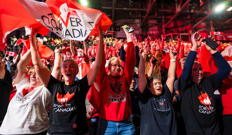 People cheer at a Forever Canadian rally in Edmonton, on Friday, Oct. 16, 2026. (John Ulan/The Canadian Press via AP)