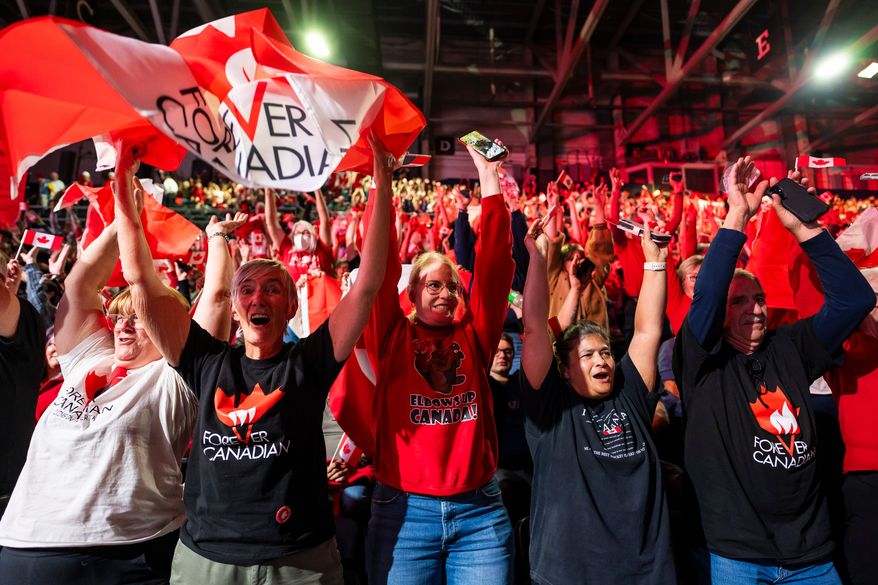 People cheer at a Forever Canadian rally in Edmonton, on Friday, Oct. 16, 2026. (John Ulan/The Canadian Press via AP)