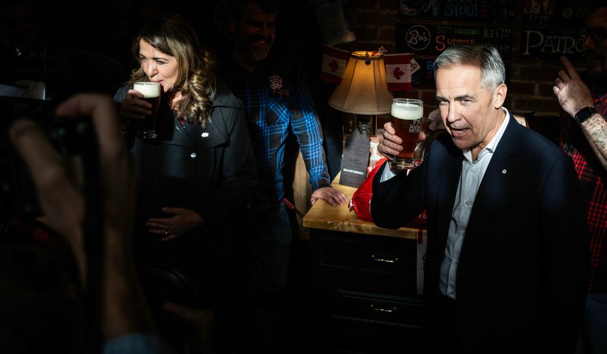 Prime Minister Mark Carney attends a national unity rally in Red Deer alongside Alberta Premier Danielle Smith on Friday, Oct. 16, 2026.. (John Ulan/The Canadian Press via AP)