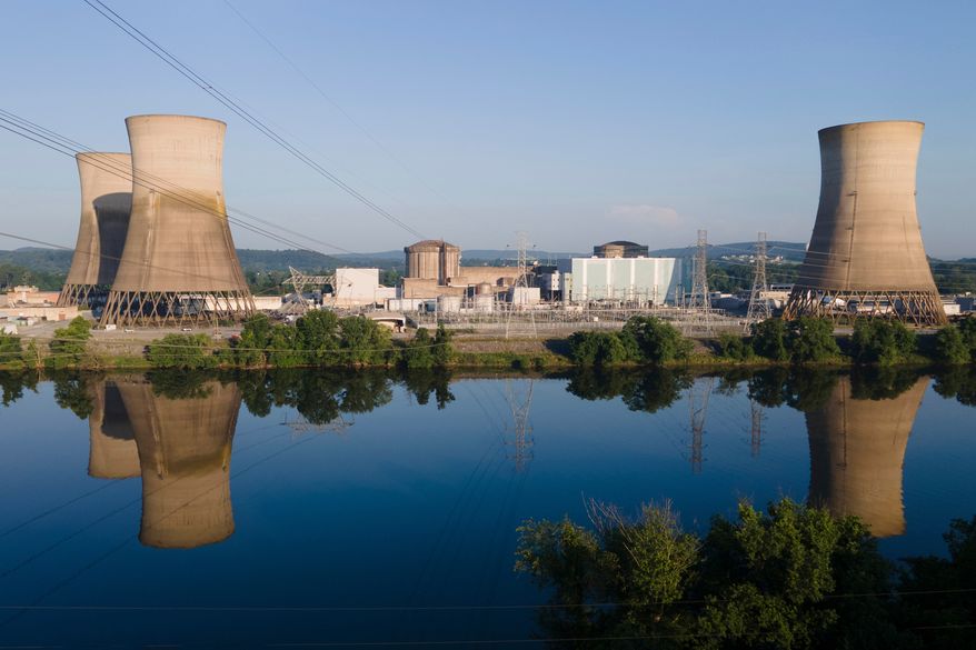 FILE - At Constellation's nuclear power plant on Three Mile Island, called the Crane Clean Energy Center, near Middletown, Pa., the cooling towers are reflected in the Susquehanna River, June 25, 2025. (AP Photo/Ted Shaffrey, File)