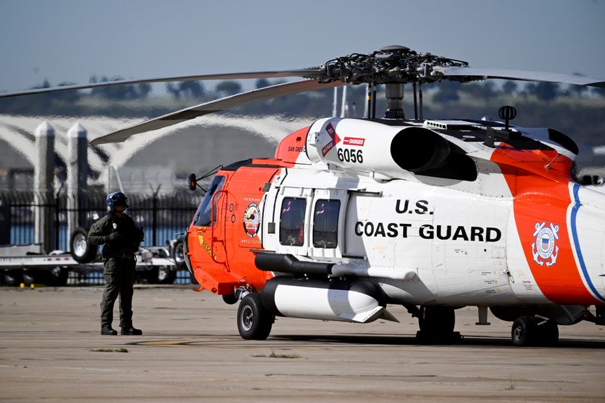 A U.S. Coast Guard prepares for lift off at Coast Guard Station San Diego, Friday, Oct. 16, 2026, in San Diego. (AP Photo/Denis Poroy)