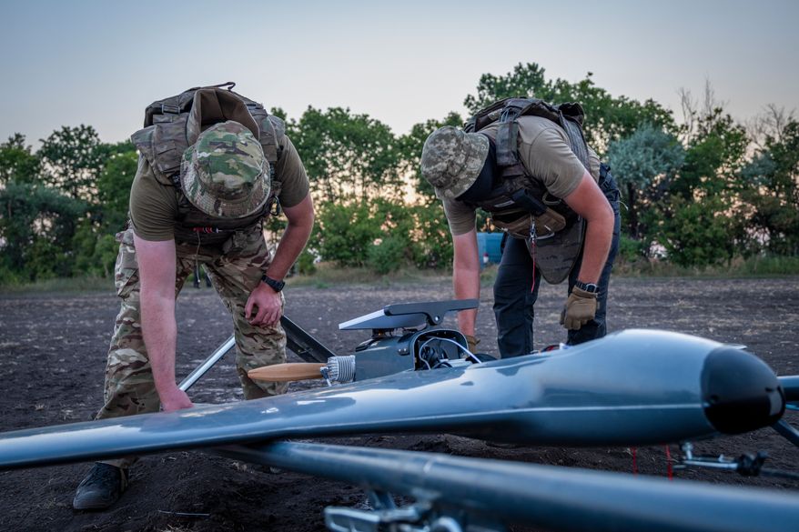FILE - Ukrainian servicemen prepare a "Chaklun" strike drone used for deep-strike operations against Russian positions in Crimea, in an undisclosed location in Ukraine, Aug. 6, 2026. (AP Photo/Dan Bashakov, File)