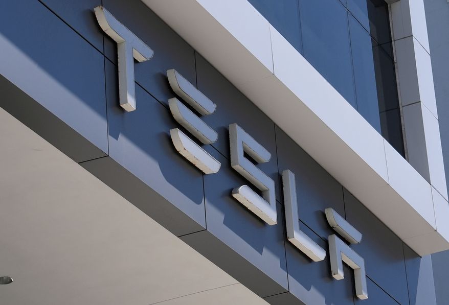 FILE - The Tesla logo is displayed at a Tesla dealership Thursday, Mar. 13, 2025, in Miami. (AP Photo/Lynne Sladky, file)