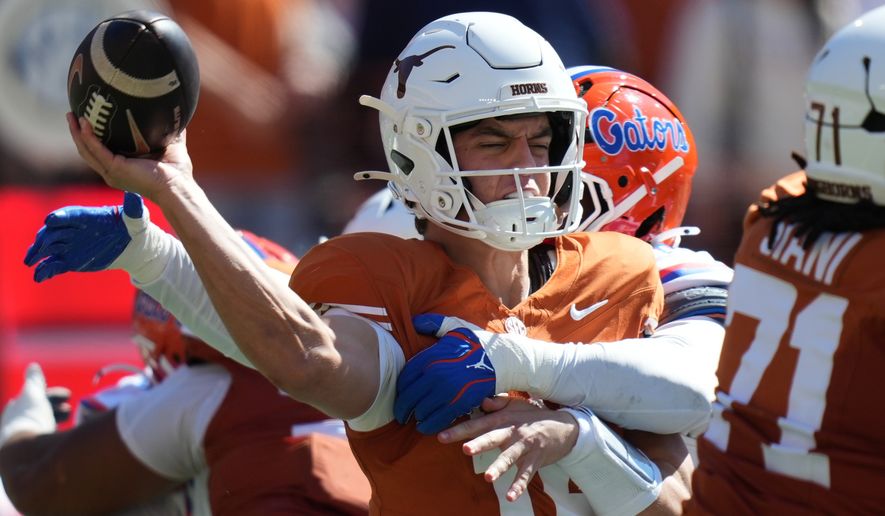 Texas quarterback Arch Manning (16) is hit by Florida linebacker Jaden Robinson (29) as he throw during the first half of an NCAA college football game in Austin, Texas, Saturday, Oct. 17, 2026. (AP Photo/Eric Gay)