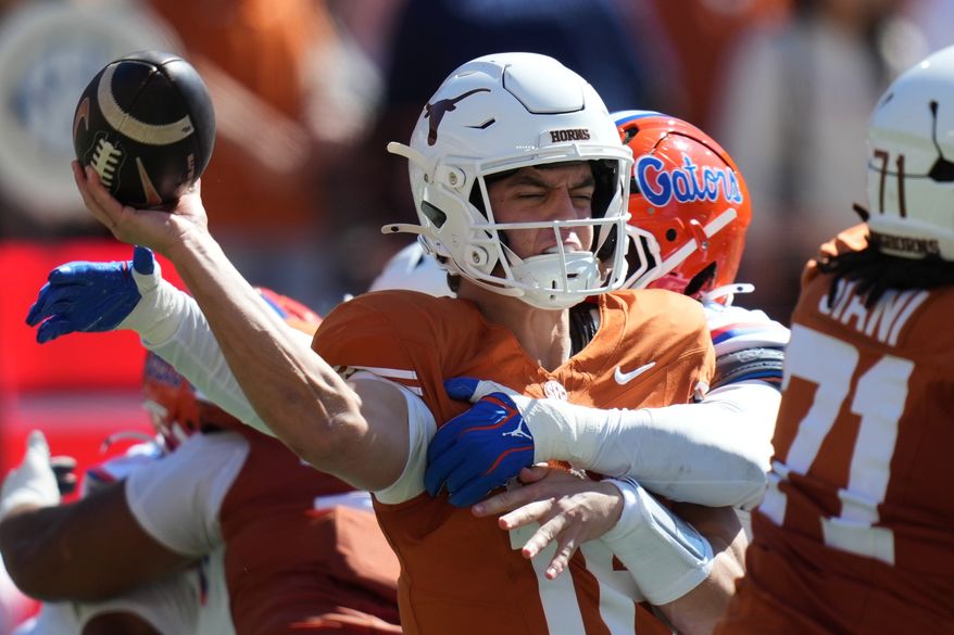 Texas quarterback Arch Manning (16) is hit by Florida linebacker Jaden Robinson (29) as he throw during the first half of an NCAA college football game in Austin, Texas, Saturday, Oct. 17, 2026. (AP Photo/Eric Gay)