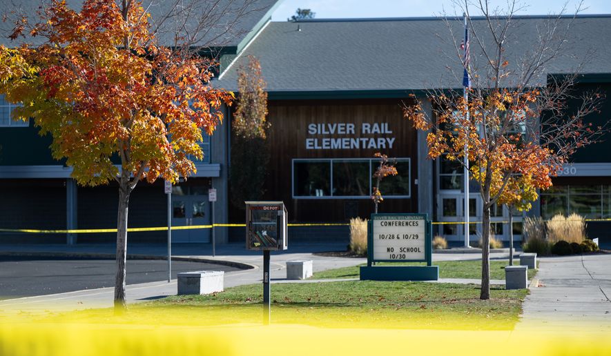 Police caution tape surrounds Silver Rail Elementary in Bend, Ore., Friday, Oct. 16, 2026, a day after a deadly shooting. (AP Photo/Joe Kline)