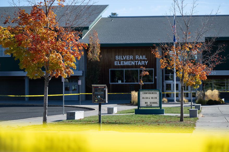 Police caution tape surrounds Silver Rail Elementary in Bend, Ore., Friday, Oct. 16, 2026, a day after a deadly shooting. (AP Photo/Joe Kline)