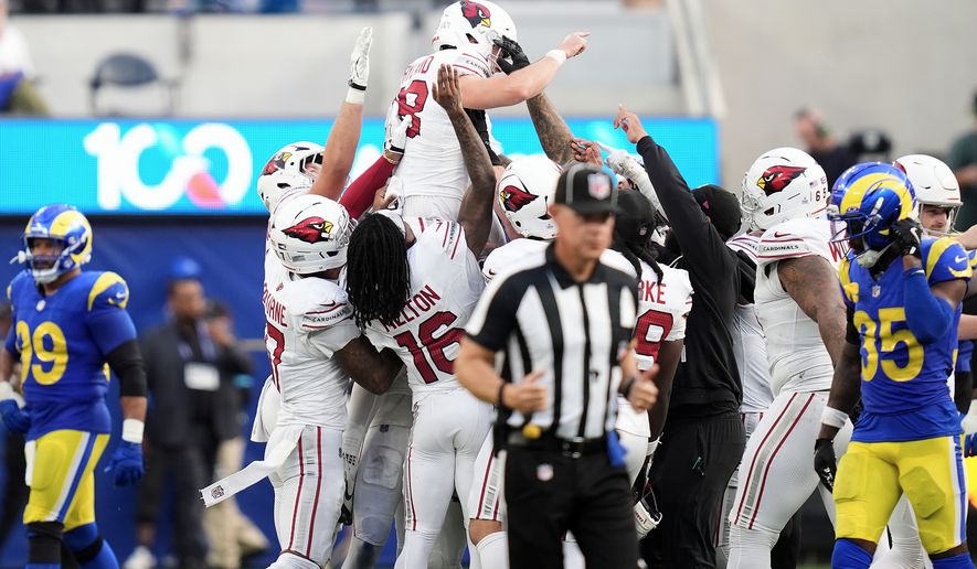 Arizona Cardinals kicker Chad Ryland, top, is congratulated by teammates after kicking the game winning field goal against the Los Angeles Rams during the second half of an NFL football game in Inglewood, Calif., Sunday, Oct. 18, 2026. (AP Photo/Gregory Bull)