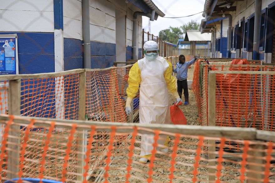 A healthcare worker walks inside a treatment center for Ebola patients in Beni, North Kivu province, eastern Congo, Wednesday, Oct. 7, 2026. (AP Photo/Sebastien Kitsa Musayi)