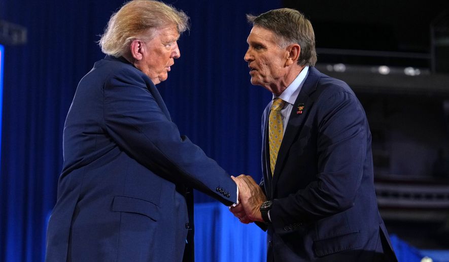 Kentucky Republican congressional candidate Ed Gallrein, right, shakes the hand of President Donald Trump at a campaign rally at Truist Arena at Northern Kentucky University, Saturday, Oct. 17, 2026, in Highland Heights, Ky. (AP Photo/Mark Schiefelbein)