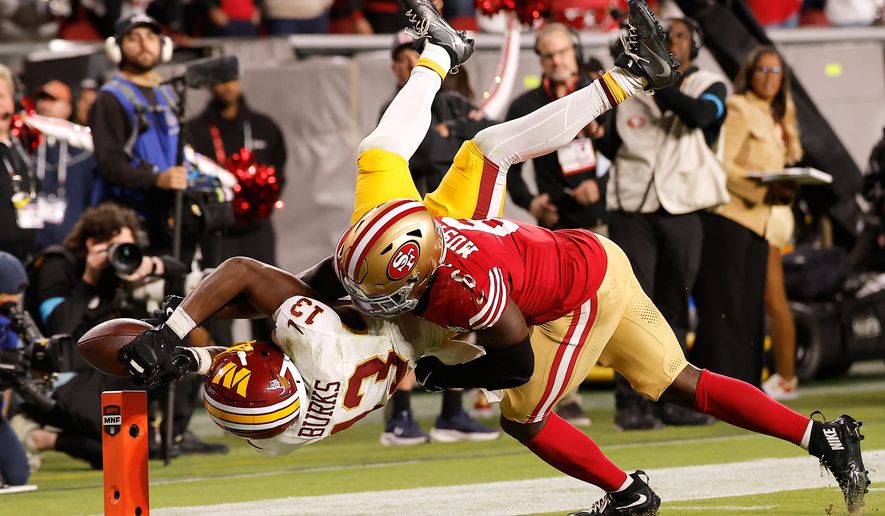 Washington Commanders wide receiver Treylon Burks (13) cannot catch a pass while being defended by San Francisco 49ers safety Malik Mustapha (6) during the second half of an NFL football game in Santa Clara, Calif., Monday, Oct. 19, 2026. (AP Photo/Kelley L. Cox)
