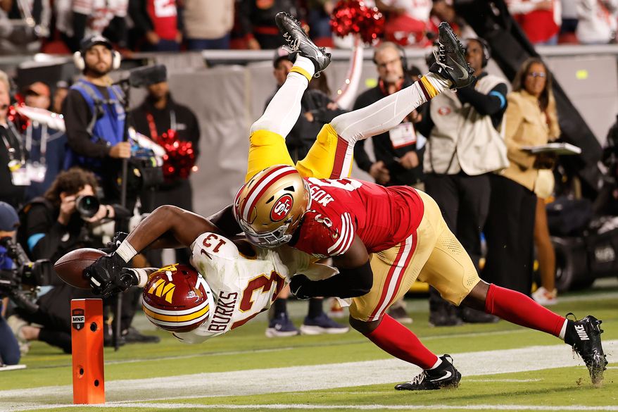 Washington Commanders wide receiver Treylon Burks (13) cannot catch a pass while being defended by San Francisco 49ers safety Malik Mustapha (6) during the second half of an NFL football game in Santa Clara, Calif., Monday, Oct. 19, 2026. (AP Photo/Kelley L. Cox)