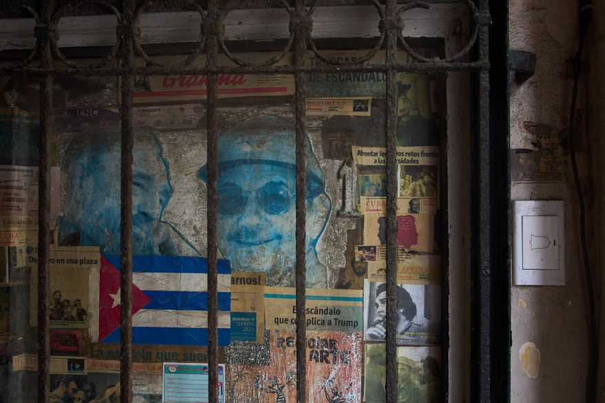 Photos of former Presidents Raúl Castro, right, and his late brother Fidel Castro cover a front door in Havana, Monday, Oct. 19, 2026. (AP Photo/Ramon Espinosa)