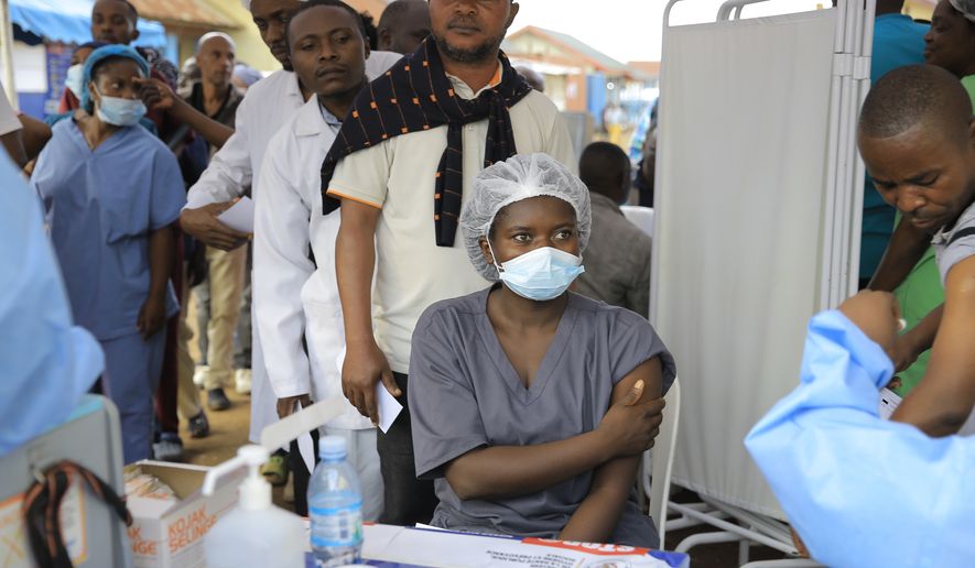 Health care workers queue to receive a dose of Ervebo vaccine against the Ebola virus in Beni, North Kivu province, eastern Congo, Friday, Oct. 16, 2026. (AP Photo/Sebastien Kitsa Musayi)