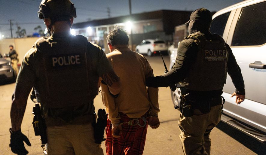 Homeland Security Investigations task force officers escort a suspect accused of illegally registering to vote during a federal operation in Commerce, Calif., Monday, Oct. 19, 2026. (AP Photo/Jae C. Hong)