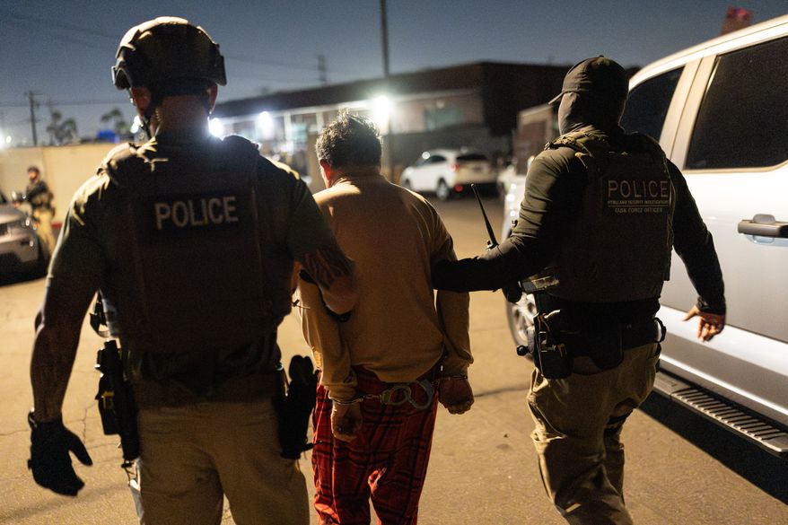 Homeland Security Investigations task force officers escort a suspect accused of illegally registering to vote during a federal operation in Commerce, Calif., Monday, Oct. 19, 2026. (AP Photo/Jae C. Hong)