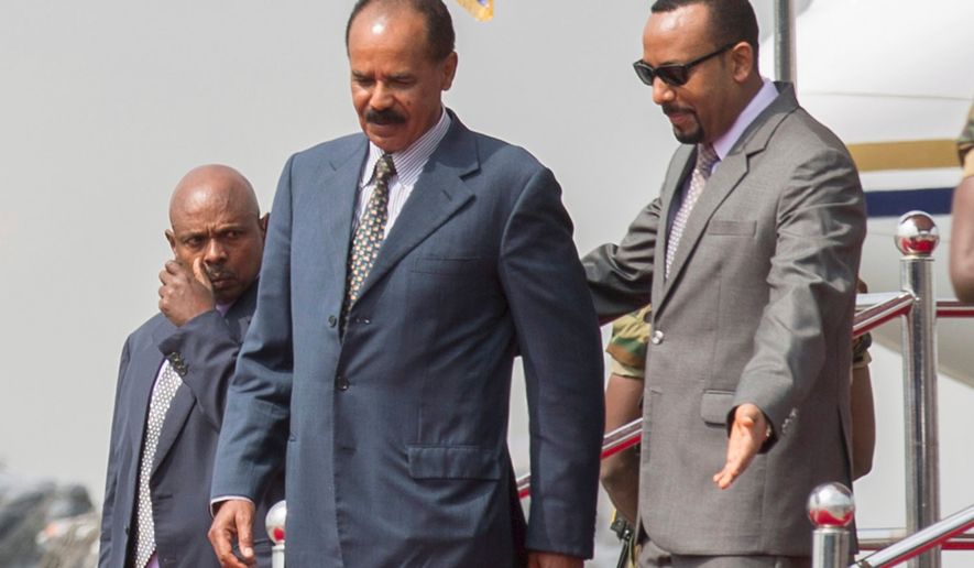 FILE -Eritrean President Isaias Afwerki, foreground left is welcomed by Ethiopia's Prime Minister Abiy Ahmed upon his arrival at Addis Ababa International Airport, Ethiopia, Saturday, July 14, 2018.(AP Photo Mulugeta Ayene, File)