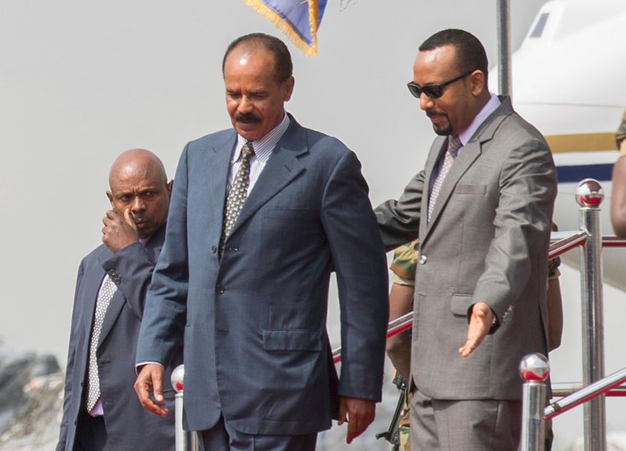 FILE -Eritrean President Isaias Afwerki, foreground left is welcomed by Ethiopia's Prime Minister Abiy Ahmed upon his arrival at Addis Ababa International Airport, Ethiopia, Saturday, July 14, 2018.(AP Photo Mulugeta Ayene, File)