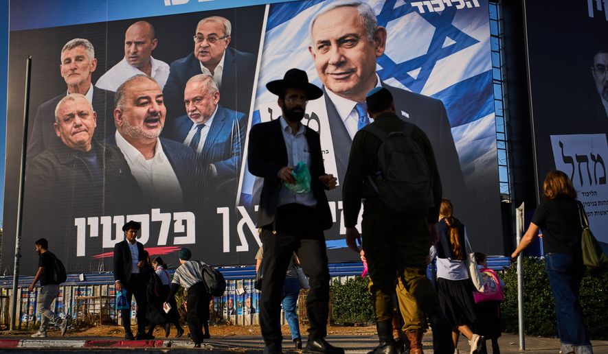 People walk past a Likud party campaign billboard featuring Israeli Prime Minister Benjamin Netanyahu alongside opposition party leaders and bearing the Hebrew slogan "Right or Palestine," ahead of Israel's general election, in Beni Brak, Israel, Sunday, Oct. 18, 2026. (AP Photo/Oded Balilty)