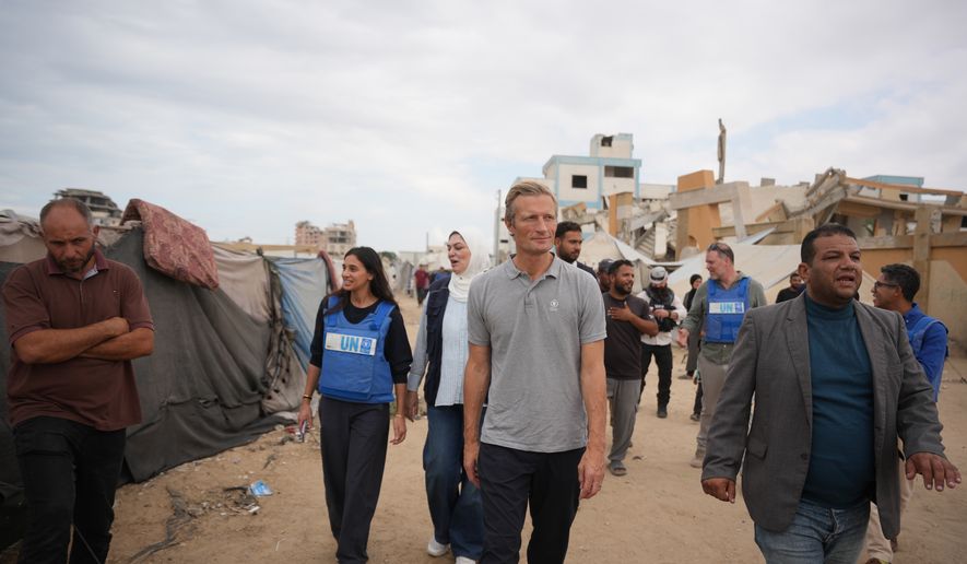 World Food Programme Executive Director Carl Skau, center, visits a camp for displaced Palestinians in Deir al-Balah, central Gaza Strip, Sunday, Oct. 18, 2026. (AP Photo/Abdel Kareem Hana)