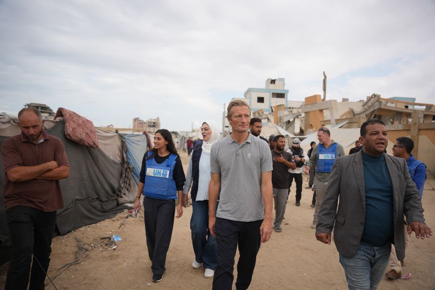 World Food Programme Executive Director Carl Skau, center, visits a camp for displaced Palestinians in Deir al-Balah, central Gaza Strip, Sunday, Oct. 18, 2026. (AP Photo/Abdel Kareem Hana)