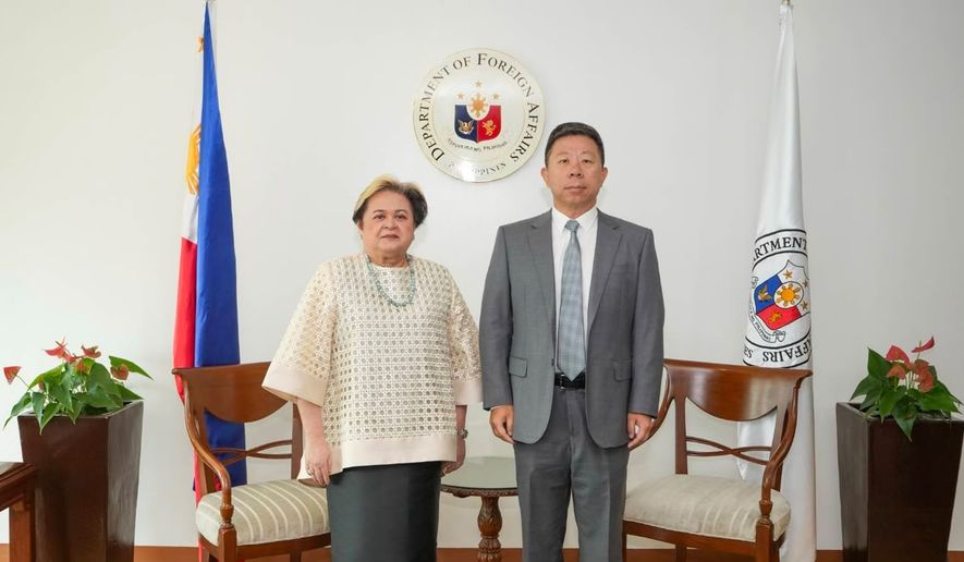In this handout photo provided by the Philippine Department of Foreign Affairs' Office of Public Diplomacy, Philippine Foreign Secretary Ma. Theresa Lazaro, left, poses with Chinese Ambassador Jing Quan after he was summoned to the department in Manila, Philippines, Monday, Oct. 19, 2026. (Philippine Department of Foreign Affairs, Office of Public Diplomacy via AP)