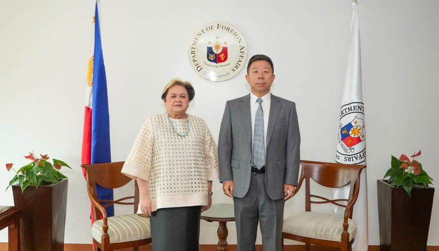 In this handout photo provided by the Philippine Department of Foreign Affairs' Office of Public Diplomacy, Philippine Foreign Secretary Ma. Theresa Lazaro, left, poses with Chinese Ambassador Jing Quan after he was summoned to the department in Manila, Philippines, Monday, Oct. 19, 2026. (Philippine Department of Foreign Affairs, Office of Public Diplomacy via AP)