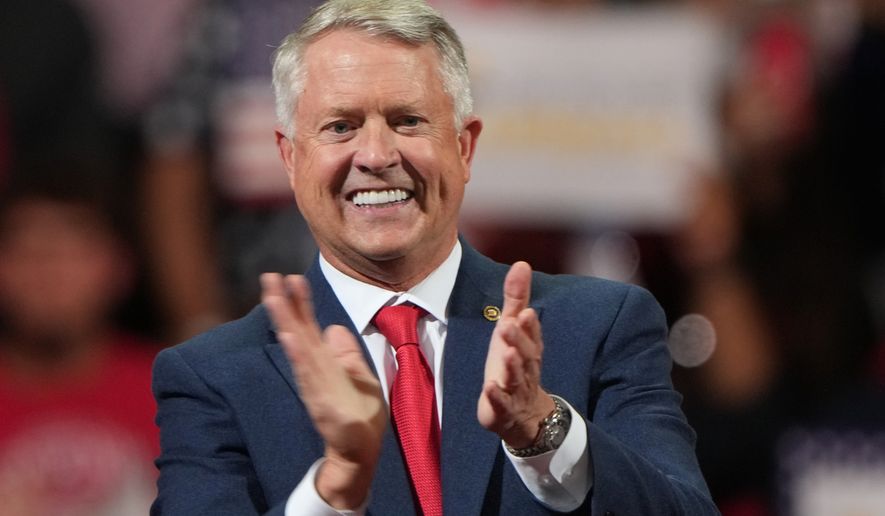 Sen. Roger Marshall, R-Kan., claps before President Donald Trump arrives at a campaign rally at Heartland Credit Union Arena, Monday, Oct. 19, 2026, in Park City, Kan. (AP Photo/Charlie Riedel)